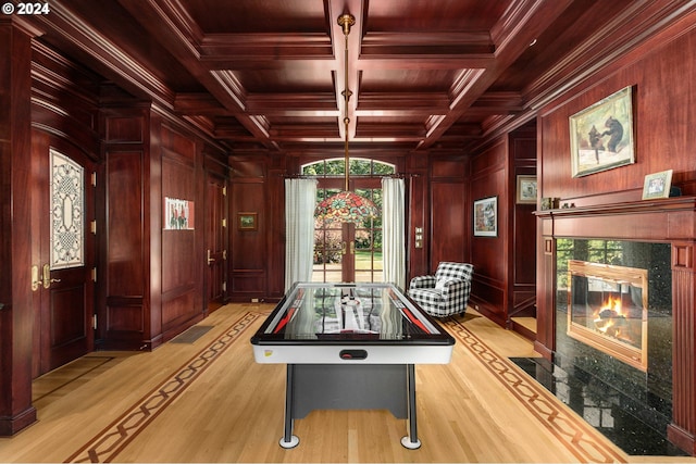 playroom with beamed ceiling, coffered ceiling, wood ceiling, and wood walls