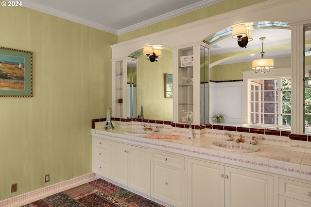 full bathroom featuring double vanity, ornamental molding, and a sink