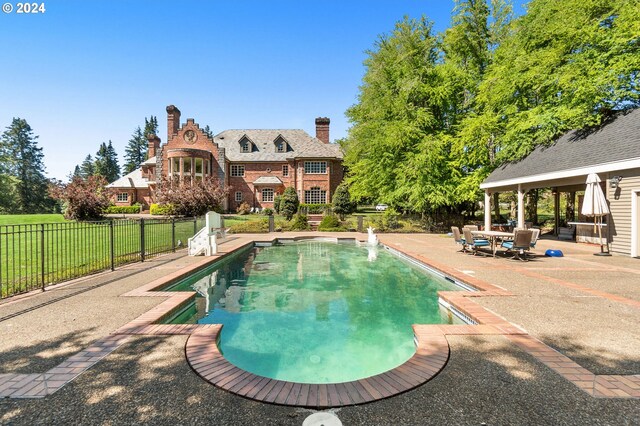 view of swimming pool featuring a patio area, a fenced in pool, and fence