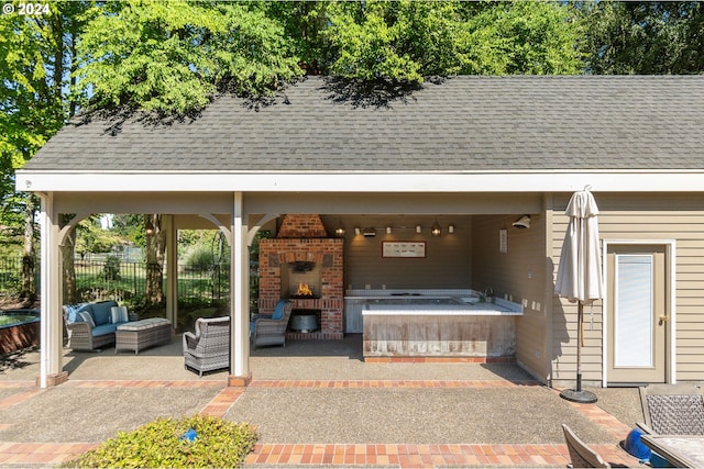 view of patio featuring an outdoor living space with a fireplace