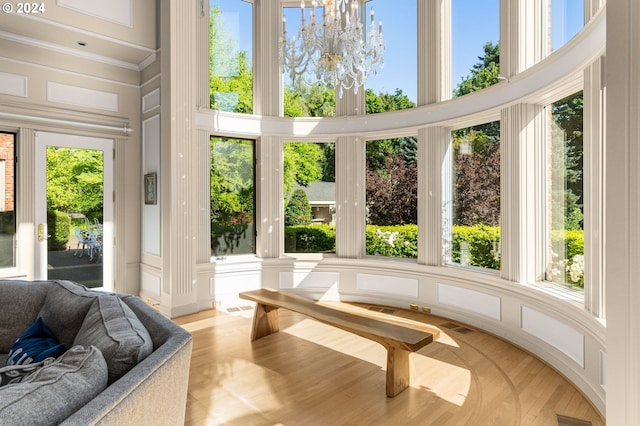 sunroom featuring a chandelier