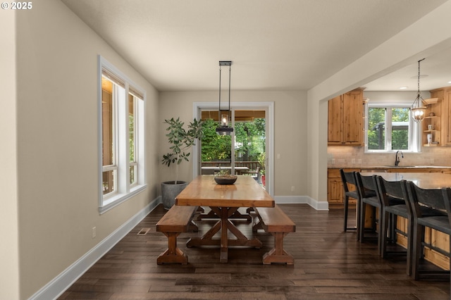 4425 SW 47th Dr, Portland, OR 97221 - dining area with baseboards and dark wood-style floors
