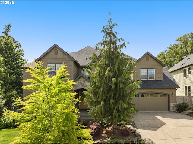 4425 SW 47th Dr, Portland, OR 97221 - craftsman inspired home with stone siding, driveway, an attached garage, a shingled roof, and board and batten siding