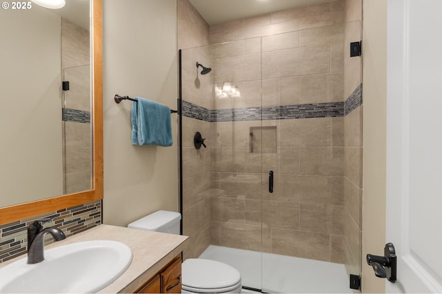 4425 SW 47th Dr, Portland, OR 97221 - bathroom with vanity, a shower stall, toilet, and decorative backsplash