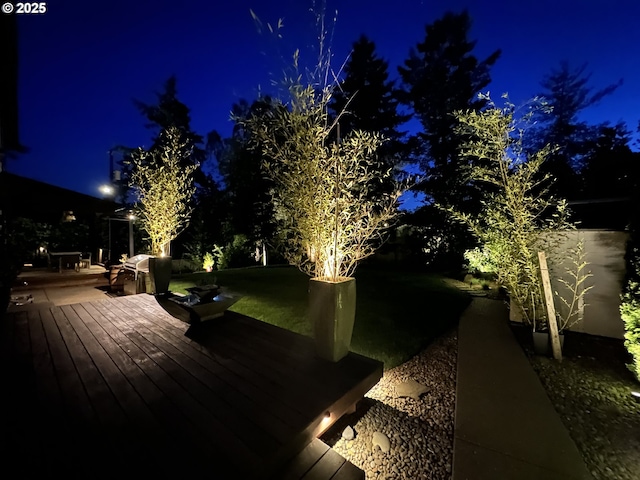 4425 SW 47th Dr, Portland, OR 97221 - yard at night with a wooden deck and a lawn