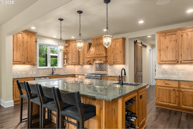 4425 SW 47th Dr, Portland, OR 97221 - kitchen featuring a sink, open shelves, a center island with sink, dark wood-style flooring, and recessed lighting