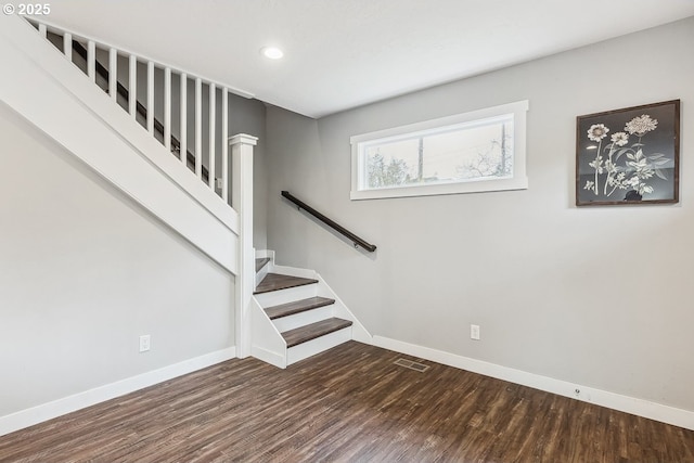 interior space with visible vents, baseboards, and wood finished floors