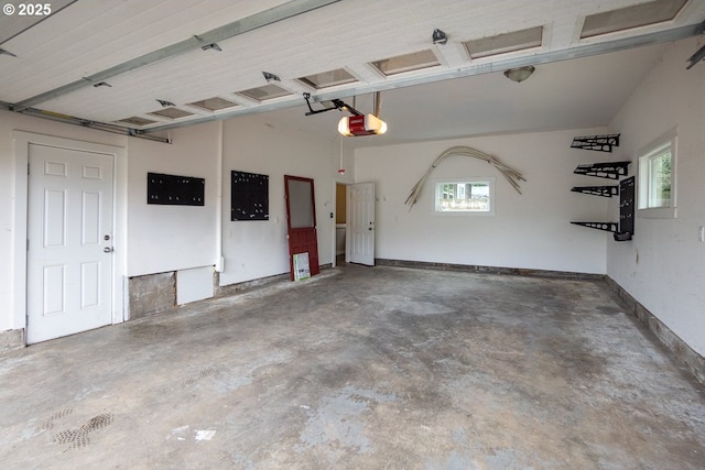 garage with a garage door opener and baseboards