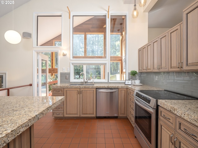 11135 SW Novare Pl, Tigard, OR 97223 - kitchen featuring stainless steel appliances, a sink, dark tile patterned floors, decorative backsplash, and high vaulted ceiling
