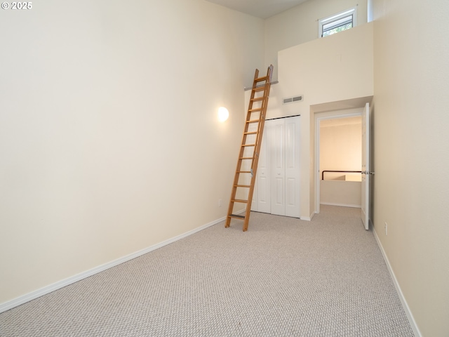 11135 SW Novare Pl, Tigard, OR 97223 - empty room with light carpet, baseboards, and a towering ceiling
