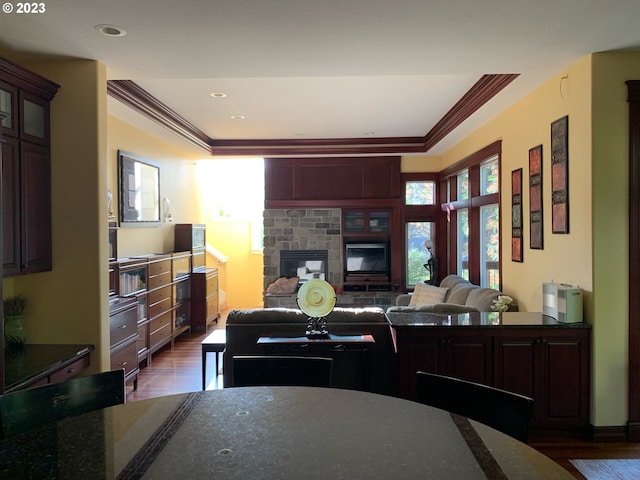 kitchen with ornamental molding, dark wood-type flooring, and a fireplace