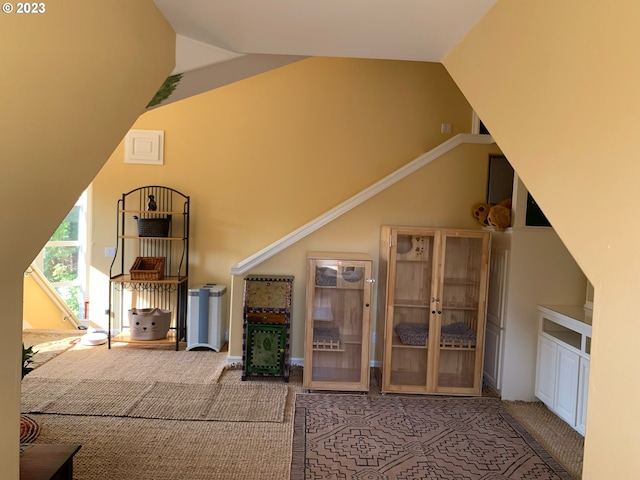 living room featuring lofted ceiling and carpet