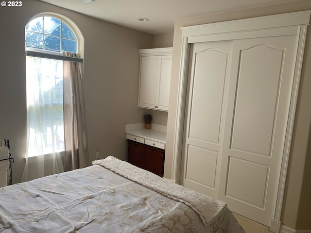 carpeted bedroom featuring a closet