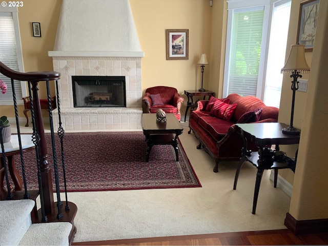 living room featuring hardwood / wood-style floors and a tiled fireplace