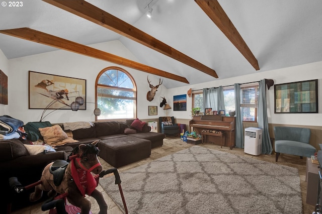 living room featuring track lighting and vaulted ceiling with beams