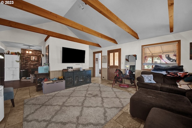 living room featuring lofted ceiling with beams, brick wall, and light tile floors