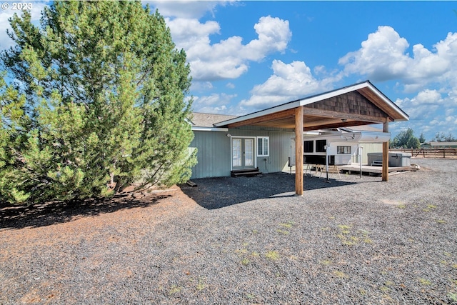 rear view of property with a wooden deck and a patio area