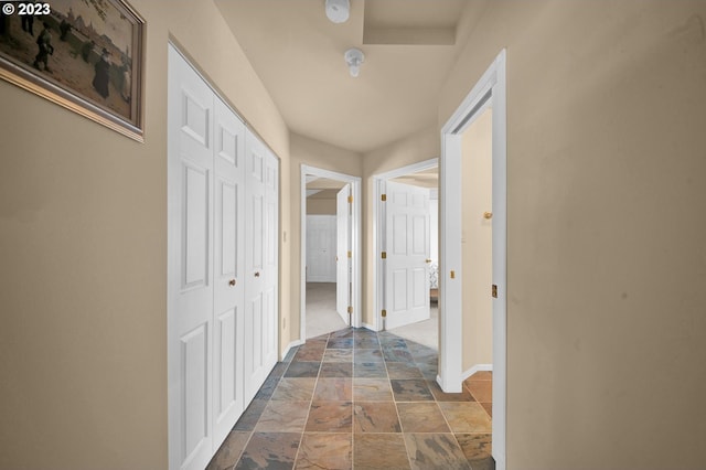 hall featuring dark tile floors