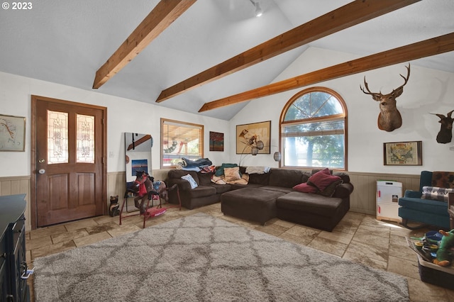 living room with vaulted ceiling with beams and light tile flooring