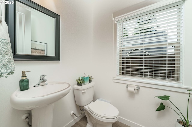 11492 SE Mt Talbert Ave, Happy Valley, OR 97086 - bathroom with baseboards, toilet, and wood finished floors