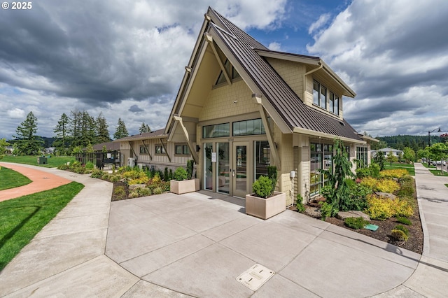 11492 SE Mt Talbert Ave, Happy Valley, OR 97086 - rear view of house featuring french doors, metal roof, a standing seam roof, and a patio area