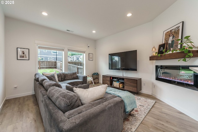 11492 SE Mt Talbert Ave, Happy Valley, OR 97086 - living area featuring recessed lighting, wood finished floors, a glass covered fireplace, and baseboards