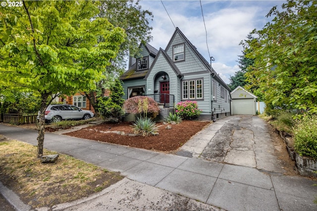 1405 NE 47th Ave, Portland, OR 97213 - bungalow featuring concrete driveway, a detached garage, and an outbuilding