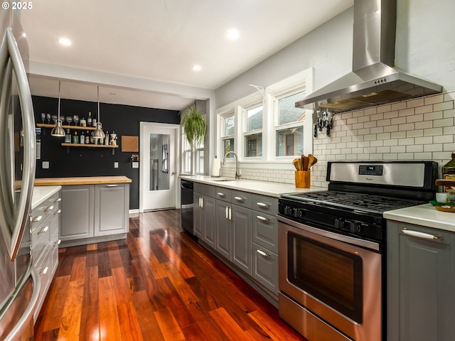 1405 NE 47th Ave, Portland, OR 97213 - kitchen featuring wall chimney range hood, stainless steel appliances, gray cabinets, open shelves, and light countertops
