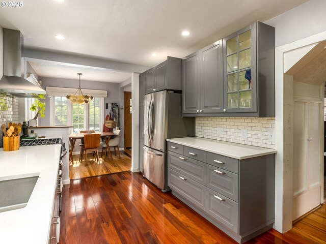 1405 NE 47th Ave, Portland, OR 97213 - kitchen featuring extractor fan, gray cabinetry, freestanding refrigerator, dark wood-type flooring, and backsplash