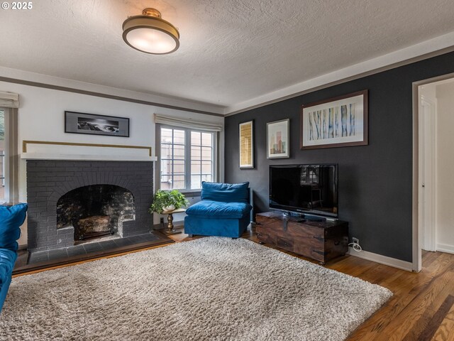 1405 NE 47th Ave, Portland, OR 97213 - living room with wood finished floors, a textured ceiling, and a brick fireplace