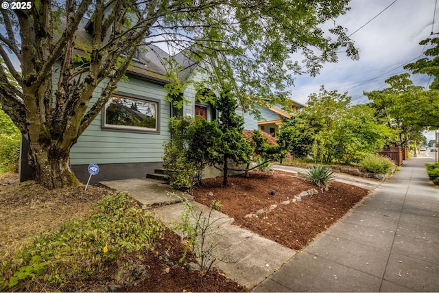 1405 NE 47th Ave, Portland, OR 97213 - view of property hidden behind natural elements with a shingled roof