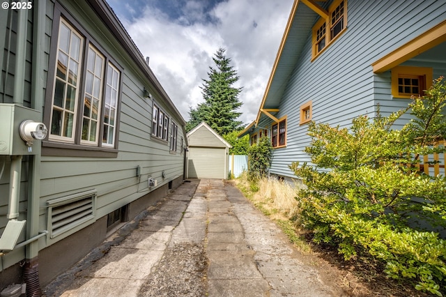 1405 NE 47th Ave, Portland, OR 97213 - view of side of home featuring a detached garage and an outdoor structure