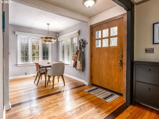 1405 NE 47th Ave, Portland, OR 97213 - foyer entrance with healthy amount of natural light, light wood-style floors, and a chandelier
