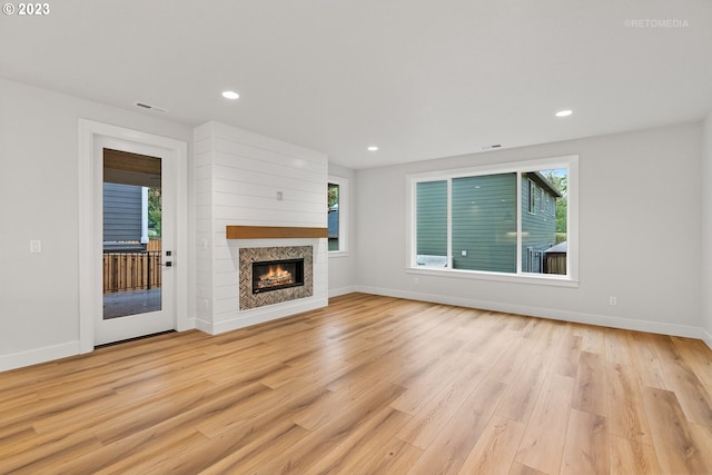 unfurnished living room featuring light hardwood / wood-style floors and a healthy amount of sunlight