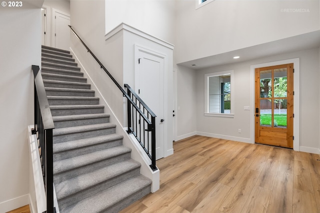 foyer with a high ceiling and light wood-type flooring