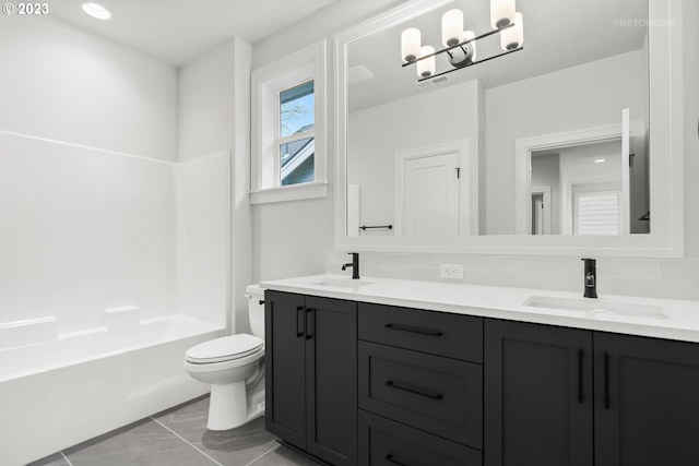 full bathroom with double sink vanity, toilet, tile flooring, and bathing tub / shower combination