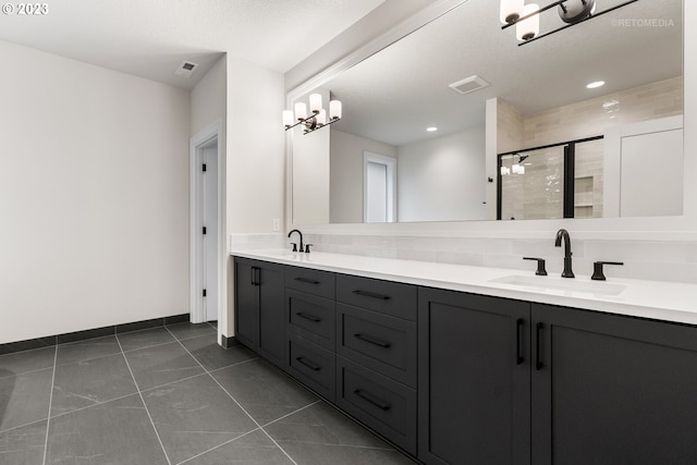 bathroom with tile flooring, a chandelier, and dual bowl vanity