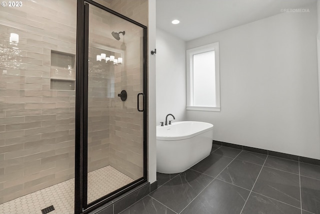 bathroom with tile flooring and independent shower and bath