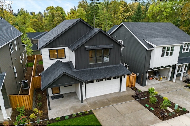 view of front of home with central AC unit and a garage