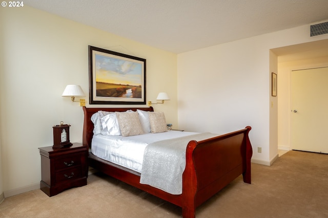 bedroom featuring light colored carpet