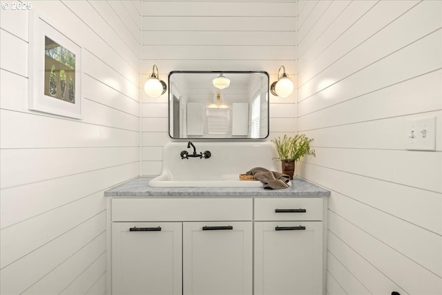 bathroom with wooden walls and vanity