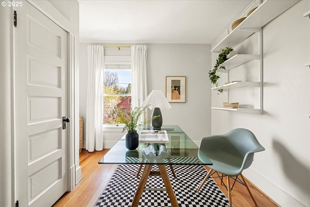 office featuring baseboards and light wood-style floors