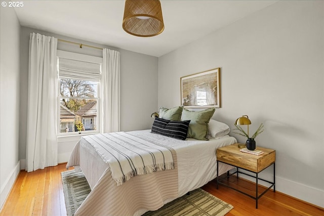 bedroom featuring baseboards and wood finished floors