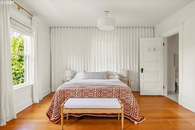 bedroom featuring light wood-style floors and multiple windows