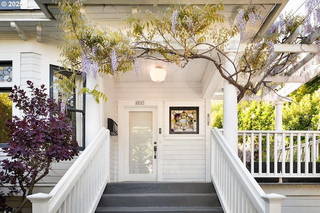 view of exterior entry featuring a porch