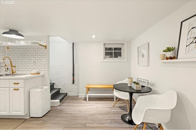 interior space featuring recessed lighting, baseboards, stairway, and light wood-style floors