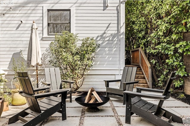 view of patio / terrace featuring a fire pit and stairway