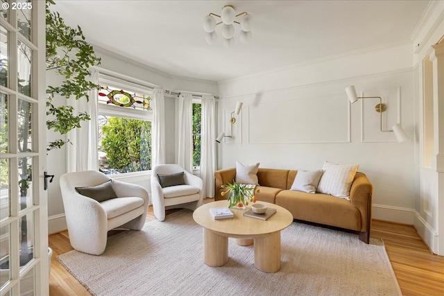 interior space with baseboards, ornamental molding, and light wood-style flooring