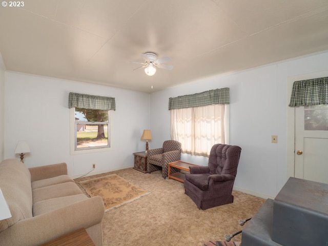 living room featuring ceiling fan, light colored carpet, and plenty of natural light