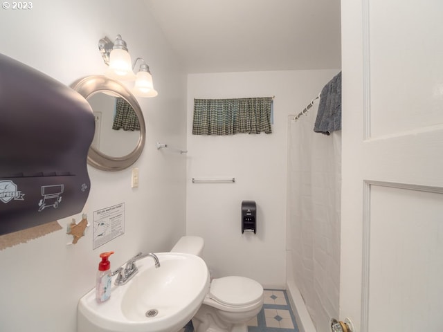 bathroom featuring toilet, tile floors, and sink